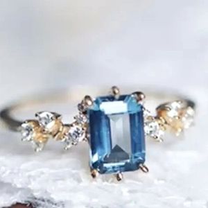 Emerald Cut Blue Topaz Engagement Ring